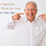 Older Man Smiling and Pointing to His Teeth. Dental Implants Could Work for You No Matter Your Age