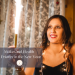 Woman Holding Sparkler Smiling Make Oral Health a Priority in the New Year
